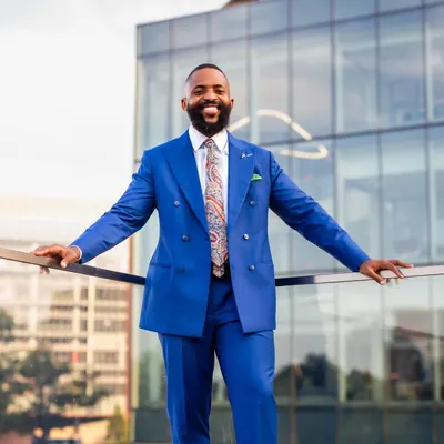 Charles Okpala, standing, city backdrop